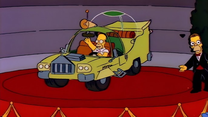 creenshot from The Simpsons showing Homer Simpson in a custom designed vehicle.